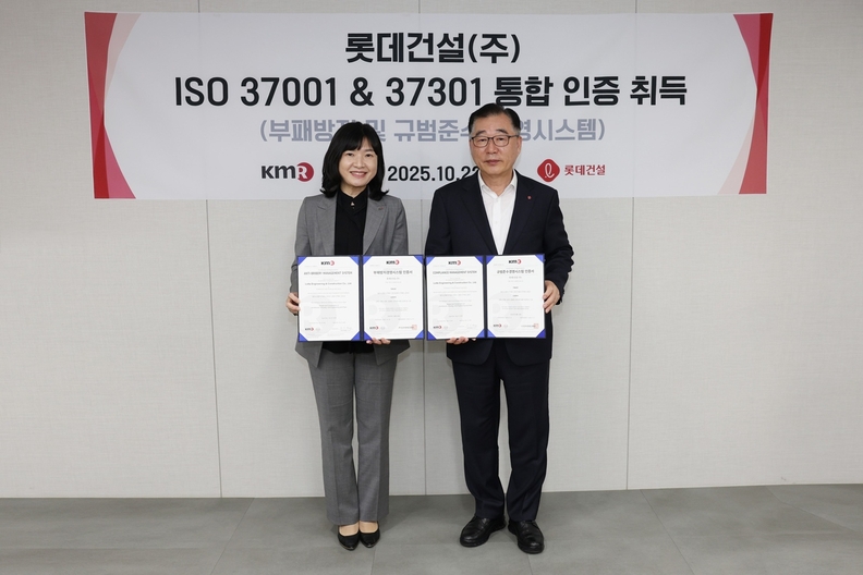 롯데건설 박현철 부회장(사진 오른쪽)과 한국경영인증원 황은주 대표이사(왼쪽)가 ISO 통합인증 수여식에서 기념촬영하고 있다